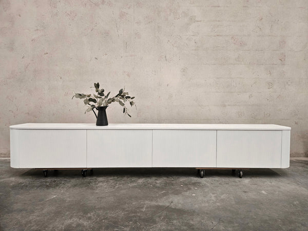 White fluted TV unit with stone top