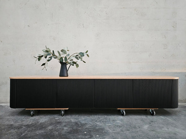 Wall-mounted curved edges fluted TV unit with solid American Oak timber top